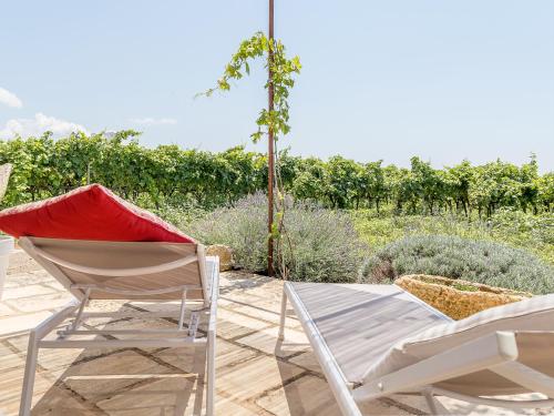 two chairs and a table in a garden at TENUTAYALA - Residenza Agrituristica in Parabita