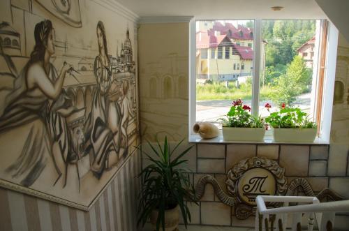 a room with a window with a painting on the wall at Triumph in Skhidnitsa