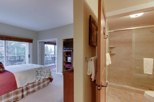 a bedroom with a bed and a bathroom with a shower at Among the Wildflowers in Sun Valley
