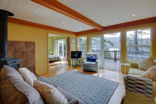 a living room with a couch and a fireplace at Shore Thing Retreat in Eastsound