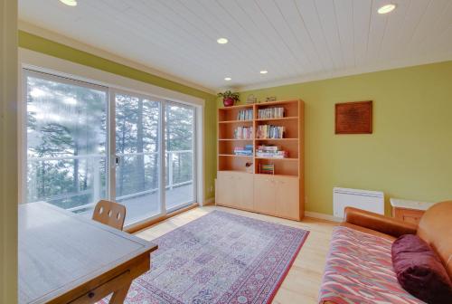 a living room with a couch and a table at Shore Thing Retreat in Eastsound