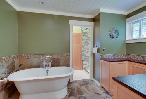 a bathroom with a tub and a sink at Shore Thing Retreat in Eastsound