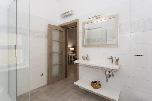 a bathroom with a sink and a mirror at Luxury Rooms Saint Jacob in Trogir
