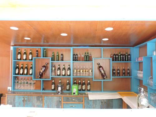 a room with a bunch of bottles on the wall at Joy Source Resort in Kathmandu