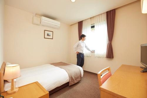 Postel nebo postele na pokoji v ubytování Hotel Folkloro Takahata