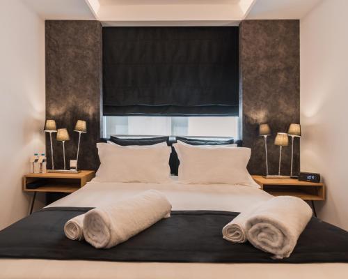 Ένα ή περισσότερα κρεβάτια σε δωμάτιο στο Acropolis Luxury Living