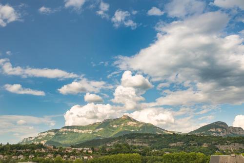 a view of a mountain under a cloudy sky at Ibis budget Chambéry Centre Ville in Chambéry