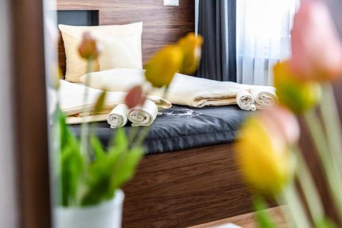 a mirror reflection of a bed in a bedroom at Hotel JÄGERHAUS in Singen am Hohentwiel in Singen