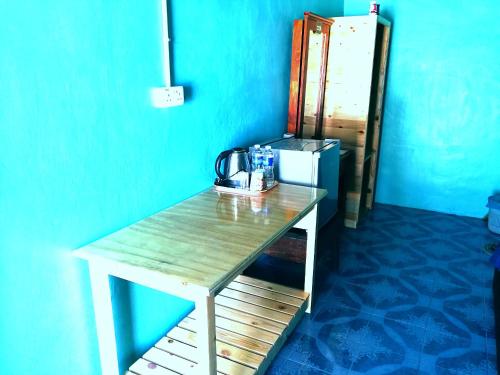 a table in a room with a tea kettle on it at Rainbow Tioman Cottage in Kampong Juara