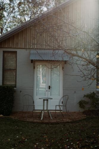 a house with a table and chairs in front of it at The Woods Pokolbin in Pokolbin