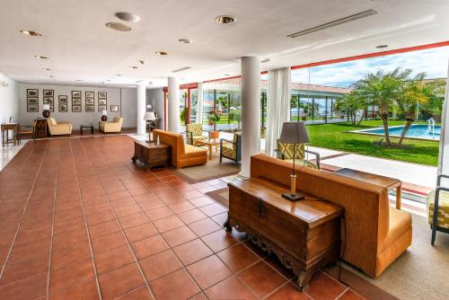 a living room filled with furniture and a large window at Parador de Nerja in Nerja