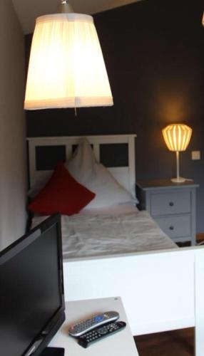 a bedroom with a bed and a desk with a computer at Auszeit am Eifelsteig in Daun