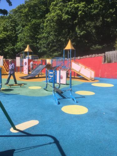 a playground with slides and play equipment in a park at Cullentra House in Cushendall