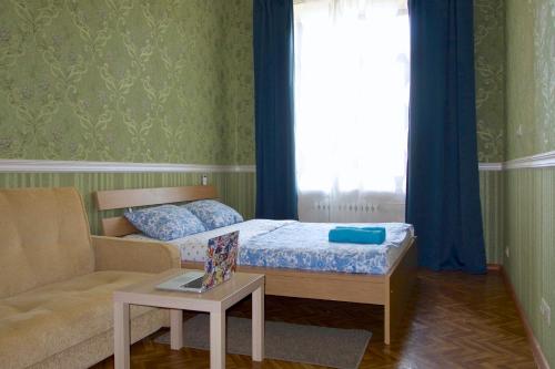 モスクワにあるKvartiraSvobodna - Kudrinskaya ploshad dom 1 - Vysotkaのベッドルーム1室(ベッド1台、ソファ、テーブル付)