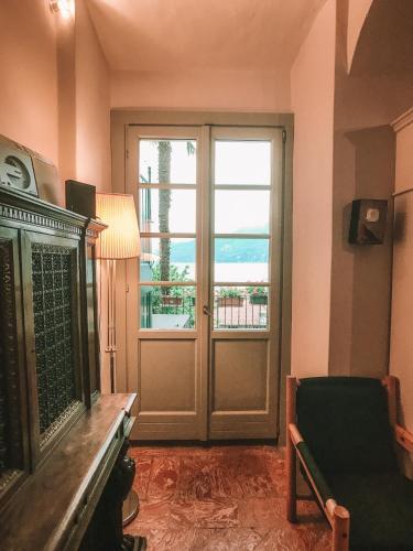 a living room with a door with a view of the ocean at Nobiallum B&B in Menaggio