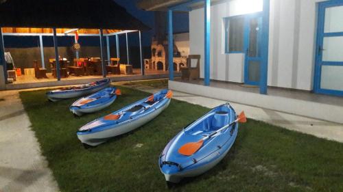four boats sitting on the grass outside of a house at Stuffino Crisan in Crisan