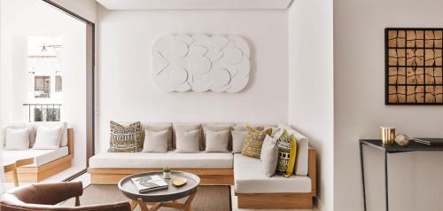 a living room with a couch and a table at Nobu Hotel Marbella in Marbella