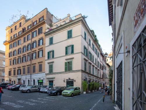 a large building with cars parked on a city street at maribea rome center in Rome