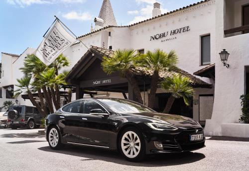 a black car parked in front of a hotel at Nobu Hotel Marbella in Marbella