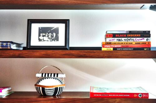 a shelf with books and a picture and a basket at Eaton DC in Washington