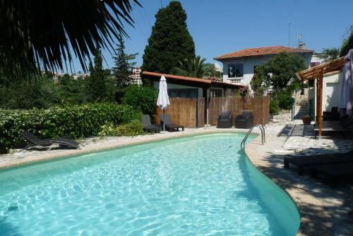 a swimming pool in the backyard of a house at Castel Enchanté in Nice