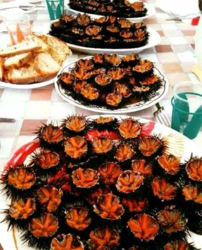 a table with several plates of food on top at Holiday Home Gionny & Mary in Taormina