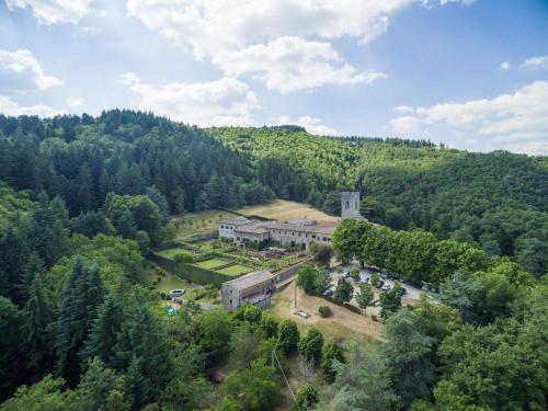 an aerial view of a building in the middle of a forest at Badia a Coltibuono in Gaiole in Chianti