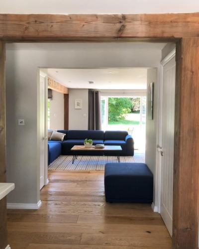 a living room with a blue couch and a table at The Cottages at Crouchers Orchards in Chichester