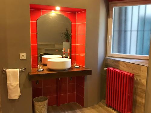 a bathroom with a sink and a mirror at Hôtel d'Alibert in Caunes-Minervois