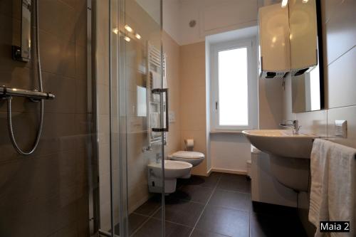 a bathroom with a sink and a toilet and a shower at Case Vacanze Maia in Matera