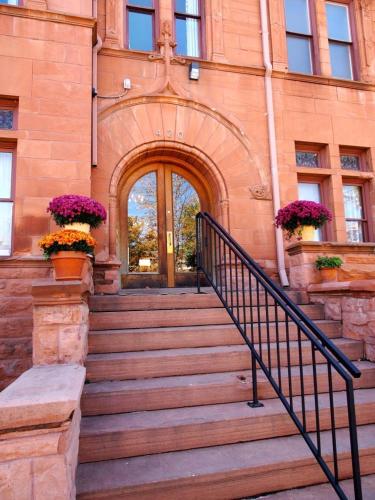 an entrance to a building with stairs and flowers at Patterson Inn in Denver
