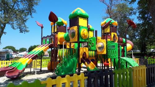 a playground in a park with a play structure at Pipo Apartment Mareda in Novigrad Istria