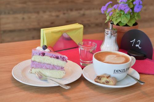 a piece of cake and a cup of coffee on a table at Stücklhof Eurasburg in Eurasburg