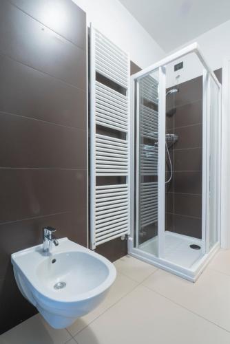a bathroom with a sink and a shower at GARDA LIVING APARTMENTS Riva del Garda in Riva del Garda