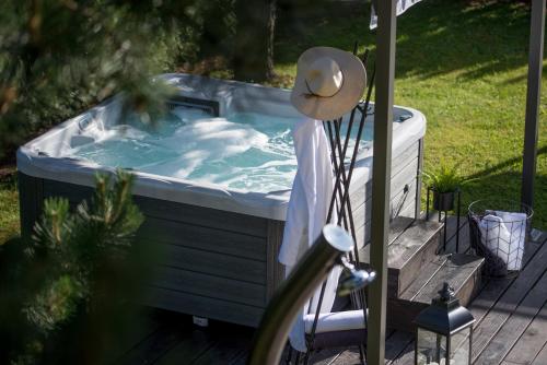 a hot tub on a deck with a hat on it at Boutique house Oreskovic in Plitvička Jezera