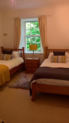 a bedroom with two beds and a window at The Lodge in Perth