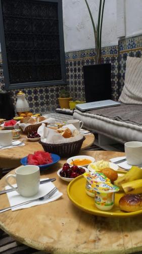 a table with plates of food on top at Boho 27 Hostel Marrakech in Marrakech