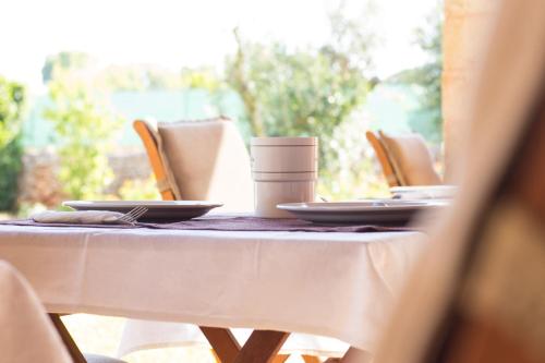 a table with a white table cloth on it at Biancolivo Gallipoli in Salento in Gallipoli
