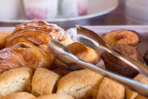 a tray of pastries with spoons in a plate of food at Biancolivo Gallipoli in Salento in Gallipoli
