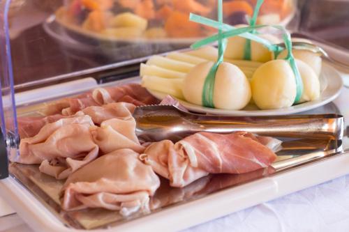 a tray of food with meat and other foods at Biancolivo Gallipoli in Salento in Gallipoli