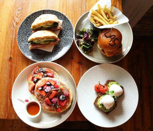 four plates with sandwiches and french fries on a table at The Gateway Lodge in Donegal