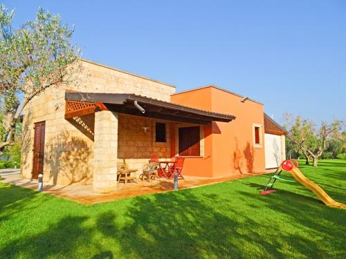 a house with a large yard with a playground at Biancolivo Gallipoli in Salento in Gallipoli