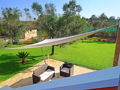 a white canopy over a patio with a lawn at Biancolivo Gallipoli in Salento in Gallipoli