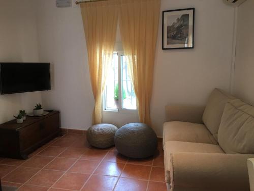a living room with a couch and a window at Apartamento Turístico Catherine in Trujillo