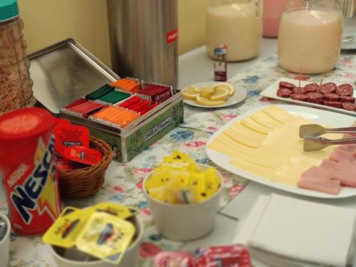 a table topped with cheese and other food on it at Hotel Crown in Melo