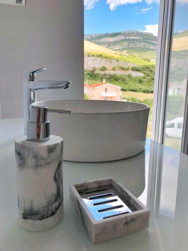 a bathroom with a sink and a bath tub at Villa Mila Kastela in Kastel Novi