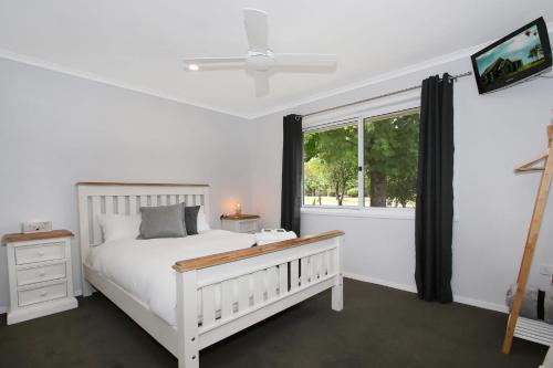 a bedroom with a white bed and a window at Marshmallow Retreat & Studio in Bright