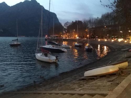 a group of boats in the water at night at Casa al Lago in Lecco