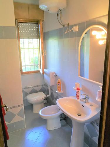 a bathroom with a sink and a toilet at Villaggio Nautilus in Bibione