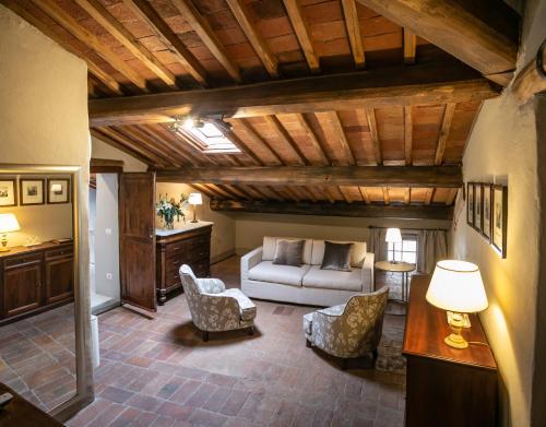 a living room with a couch and chairs and a table at Palazzo Leopoldo Dimora Storica & Spa in Radda in Chianti